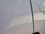 a car door handle with a dog sticking out of it ' s side