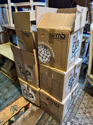 boxes stacked on top of each other on the floor in a living room