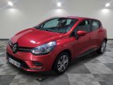 une voiture rouge garée sur le sol en damier d'un garage