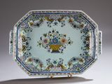 underside view of a blue and white plate with flowers and birds on it