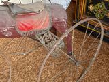 a old fashioned baby carriage sitting on the floor