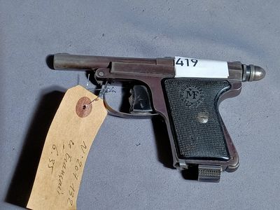a gun with a tag attached to it sitting on a table