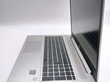 a laptop that is open on a white surface