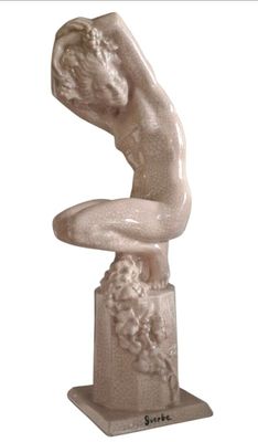 statue d'une femme assise sur un piédestal, les mains posées sur les genoux