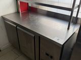 stainless steel counter top in a commercial kitchen with red bins