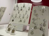 many different types of jewelry displayed on display in a store