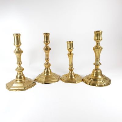 three brass candlesticks on a white background with a white background