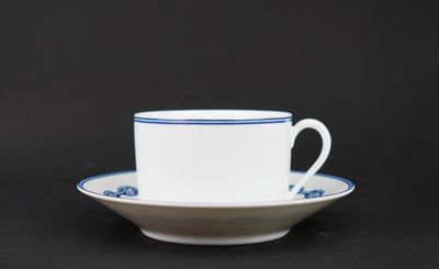 a close up of a cup and saucer on a black background