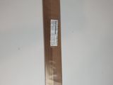 a piece of cardboard on the wall with a sticker attached to it
