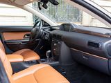 the interior of a car with tan leather seats and a black dashboard