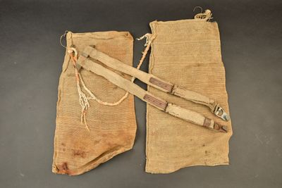 an old pair of canvas and leather holsters on a table