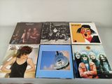 several albums of various music are sitting on a glass table