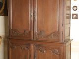 a large wooden cabinet in the corner of a room