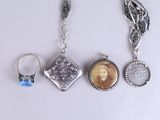 a silver necklace with a picture of a woman on it