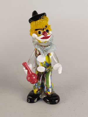a small toy clown with a red hat and a black top hat