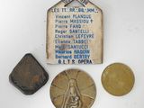 several coins and a medal are sitting on a white surface