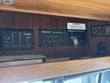 a wooden shelf with a bunch of electronic devices on it