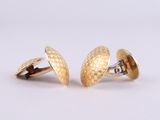 two pairs of gold cufflinks on a white background