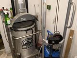 a machine that is next to a trash can in a room