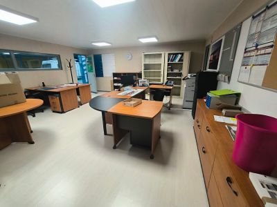 a room with a lot of desks and chairs in it