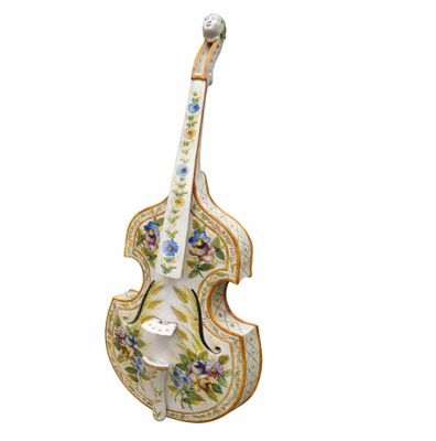 a close up of a violin shaped figurine on a white background