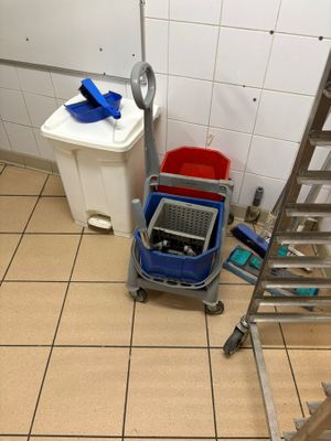 tiled floor in a bathroom with a laptop computer on a cart