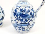 two blue and white vases sitting next to each other