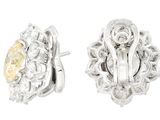 a pair of earrings with yellow and white diamonds on a white background