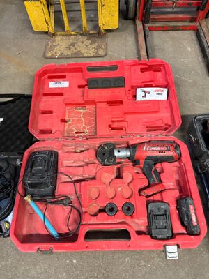 a red tool case with tools in it on the floor