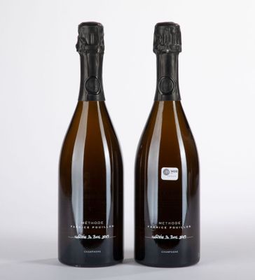 deux bouteilles de champagne posées l'une à côté de l'autre sur une surface blanche