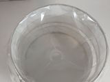 a clear plastic bowl with a lid on a table