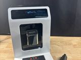 a close up of a coffee maker on a wooden table