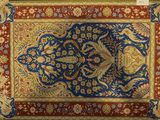 a close up of a blue and red rug with a floral design