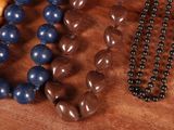 a wooden table with a bunch of beads on it