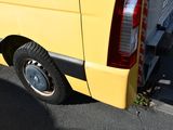 a yellow van that is parked on the side of the road