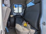 a seat in the back of a van with a stuffed animal in it