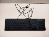 a black keyboard and mouse sitting on a white table