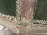 a close up of a green chair with a metal frame