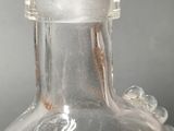 a clear glass bottle with an octopus inside of it