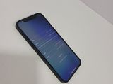 the back of a black phone sitting on top of a white table