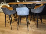 four stools that are sitting in front of a bar