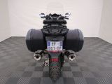 a motorcycle that is parked on a checkered floor