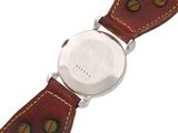 a close up of a wrist watch with a brown leather strap