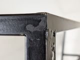 a close up of a metal shelf with a mirror on it