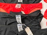three men ' s briefs are lined up on a white surface