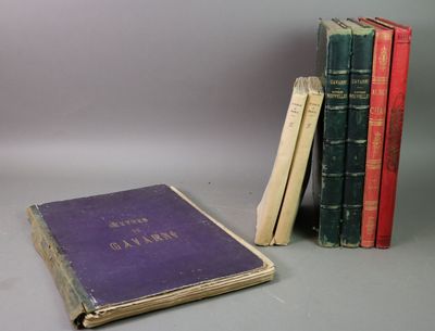 several old books are stacked on top of each other on a table