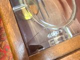 a glass case with a clock inside of it on a table