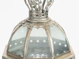 a silver and glass lantern with a crown on top