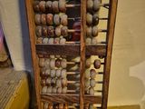 a wooden rack with a number of balls on it