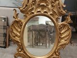 a mirror that is sitting on a table in a room